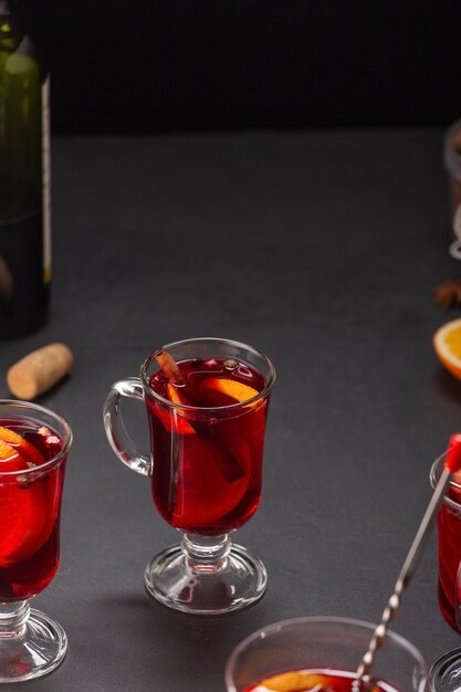 Alcoholische glühwein met fruit en kruiden op een donkere achtergrond, traditionele alcoholische drank, Kerstmis