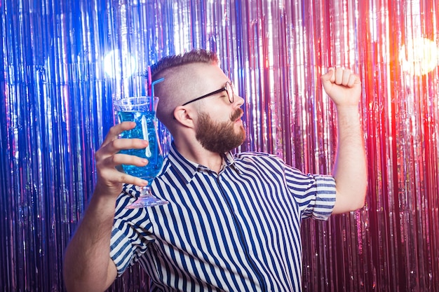 Photo alcoholism, fun and fool concept - drunk crazy guy at party in a nightclub.