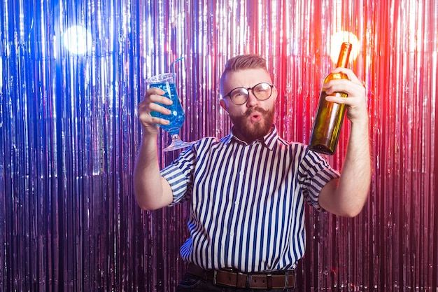 Alcoholism, fun and fool concept - Drunk crazy guy at party in a nightclub.