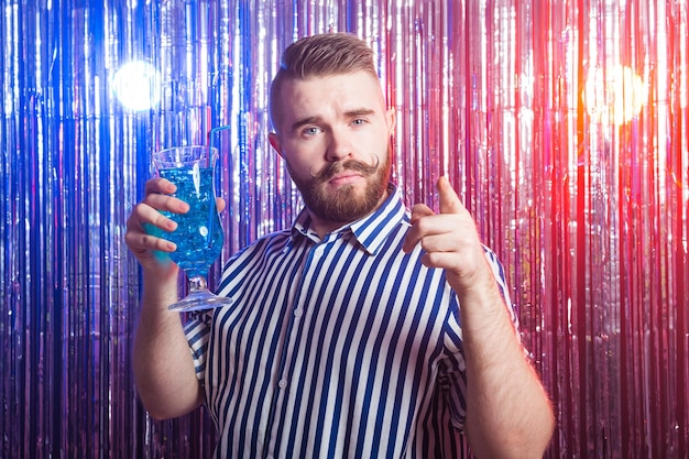 Photo alcoholism, fun and fool concept - drunk guy at party in a nightclub.