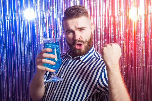 Alcoholism, fun and fool concept - Drunk guy at party in a nightclub.