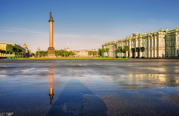 Alexander column on Palace square in St. Petersburg with a reflection on the wet asphalt