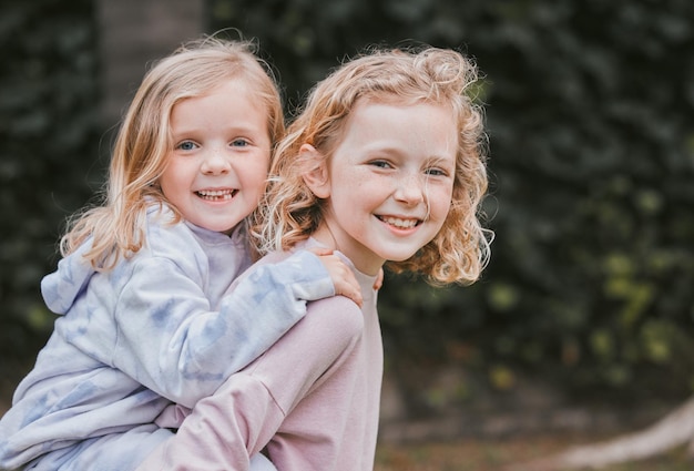 All aboard the sister express Shot of two adorable little girls having fun in a garden