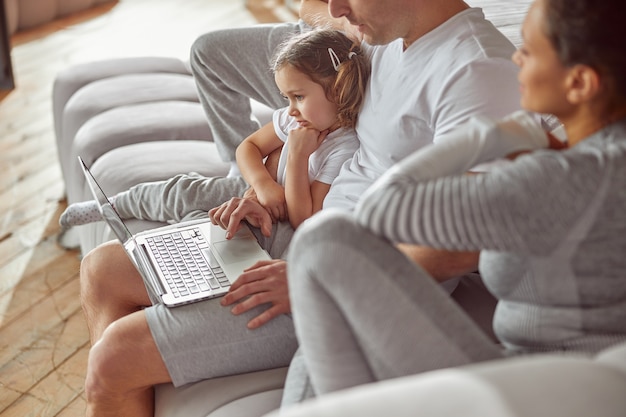 All family using laptop together at home