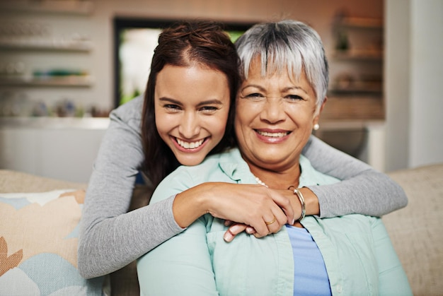 All grown up but still her mothers daughter Cropped portrat of a young woman hugging her mature mother in the living room