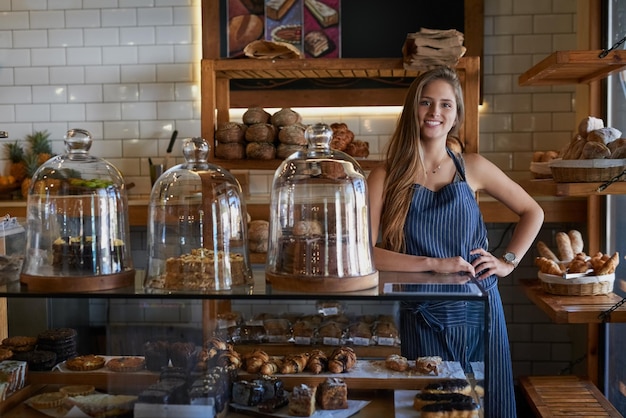 All our treats are baked to perfection Portrait of a young business owner standing behind the counter of her bakery