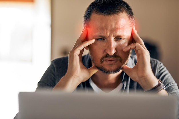 All this planning is giving me a headache Cropped shot of a man experiencing a headache at home