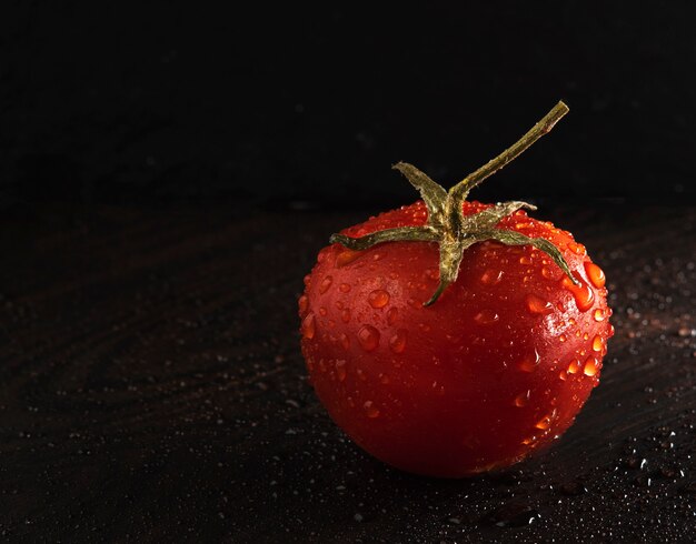 Alleen van de achtergrond tomatenkers donkere controle lichte natte macro dichte omhooggaand