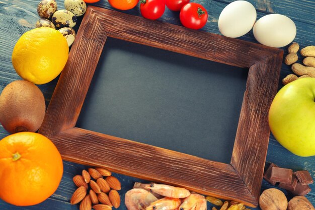 Allergic food with blank board on wooden background