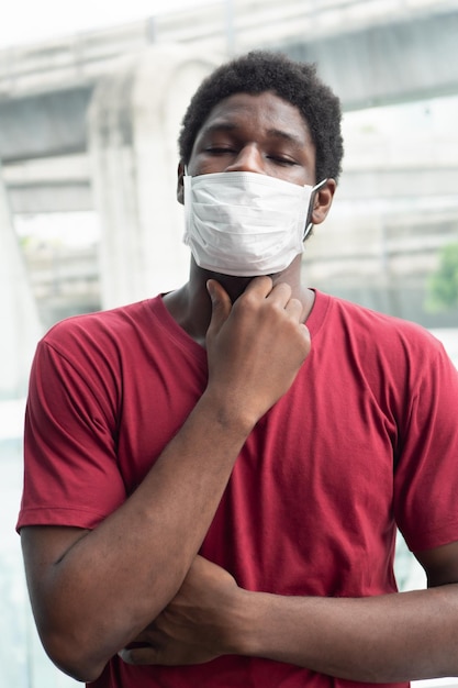 Allergic sick black African man coughing with sore throat concept of african man with allergy pneumonia sore throat lung inflammation influenza flu cold sickness social distancing concept