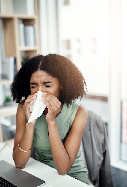 Allergies blowing nose or sick woman in office or worker with hay fever sneezing or illness in workplace Female sneeze or business person with toilet paper tissue allergy virus or disease at desk