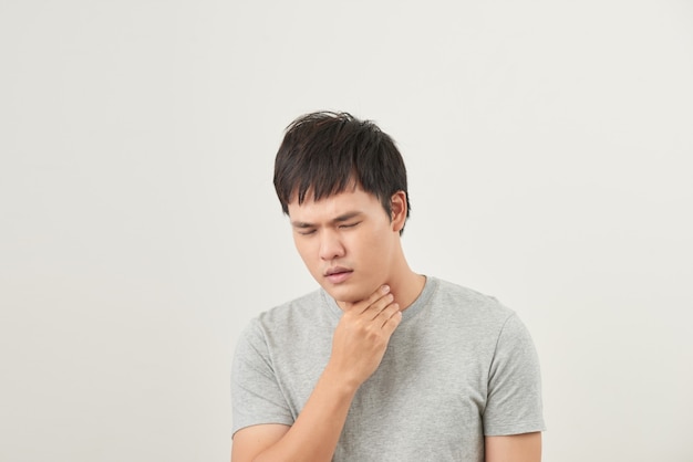 Allergies and sore throat concept. Sick young man on white background