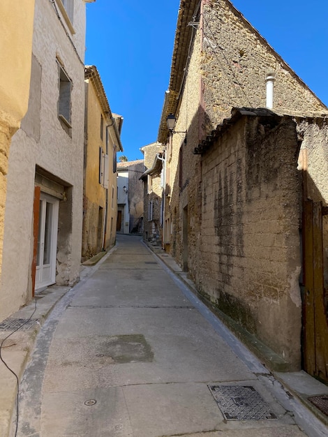 Alley amidst old buildings in city against sky