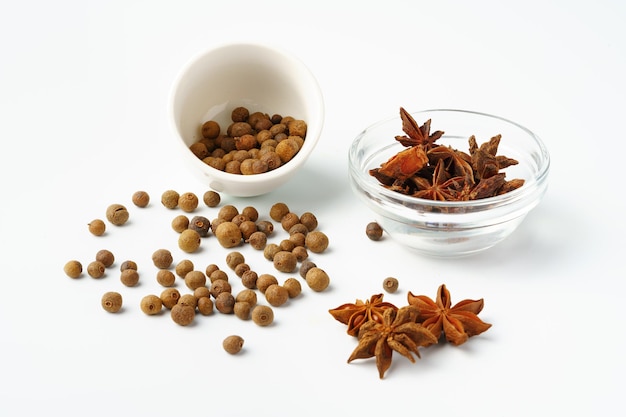 Allspice and anise stars on white background