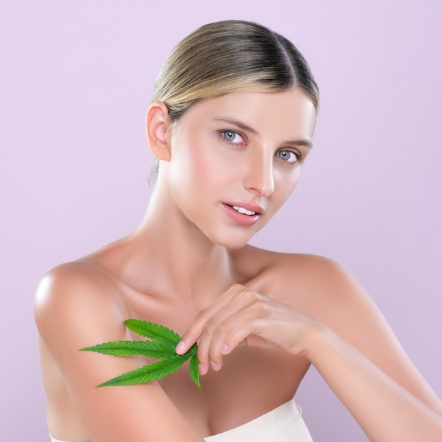 Alluring beautiful woman portrait hold green leaf as cannabis skincare concept