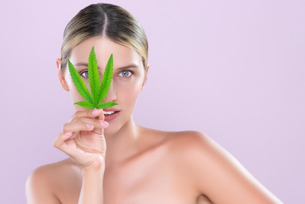 Photo alluring beautiful woman portrait hold green leaf as cannabis skincare concept