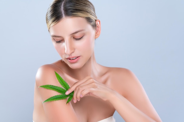 Alluring beautiful woman portrait hold green leaf as cannabis skincare concept