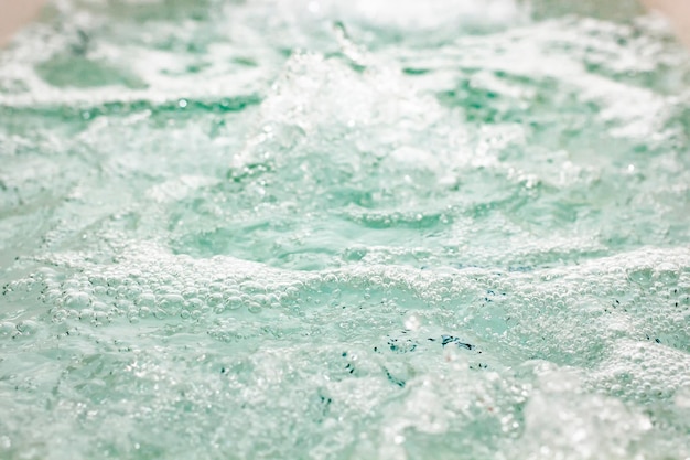 Alluring blue transparent water with air bubbles in a luxurious hot tub