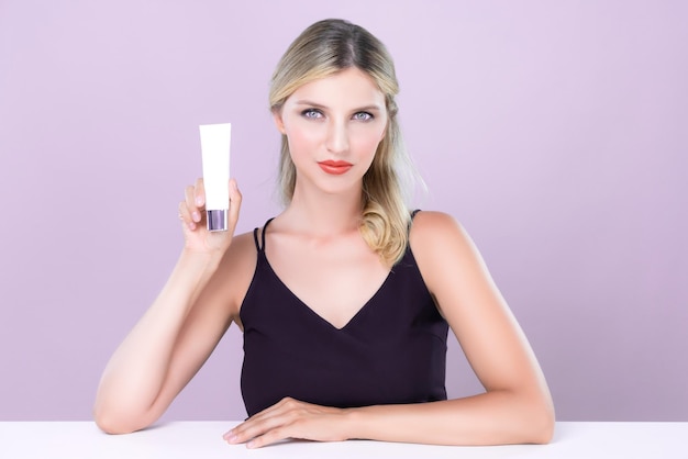 Alluring portrait of perfect skin woman holding mockup moisturizer tube