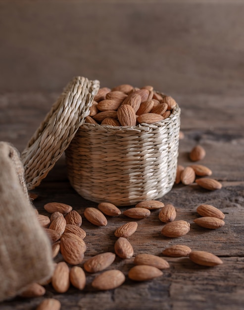 Almond in basket on blurred wood