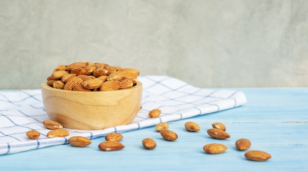 Almond on a blue wooden table.