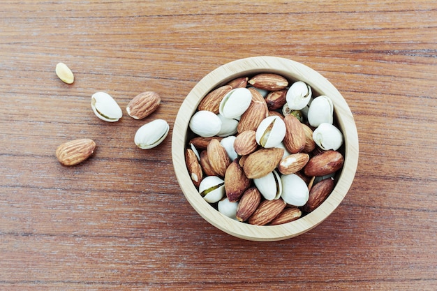 Almond in a bowl on wooden.