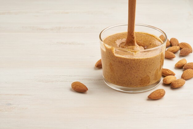 Almond butter, raw food paste made from grinding almonds into nut butter, crunchy and stir