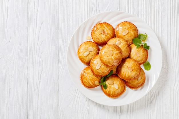 Almond cookies on white plate top view