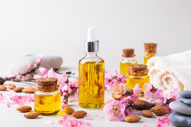 Almond essential oil in a bottles with spring blossom branches