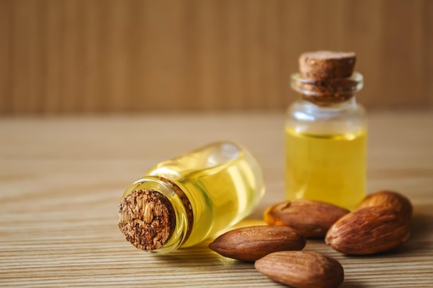 Almond essential oil in a small bottle Selective focus