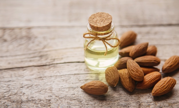 Almond essential oil in a small bottle. Selective focus.