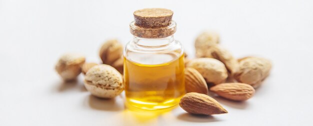 Photo almond essential oil in a small bottle