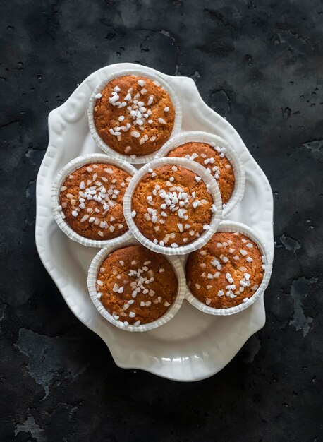 Almond flour muffins on a plate on a dark background top view