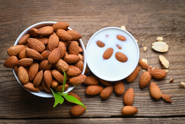 Almond milk and Almonds nuts on on wooden background Delicious sweet almonds on the table roasted almond nut for healthy food and snack top view