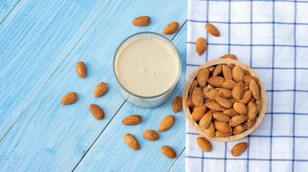 Photo almond milk on a blue wooden table.