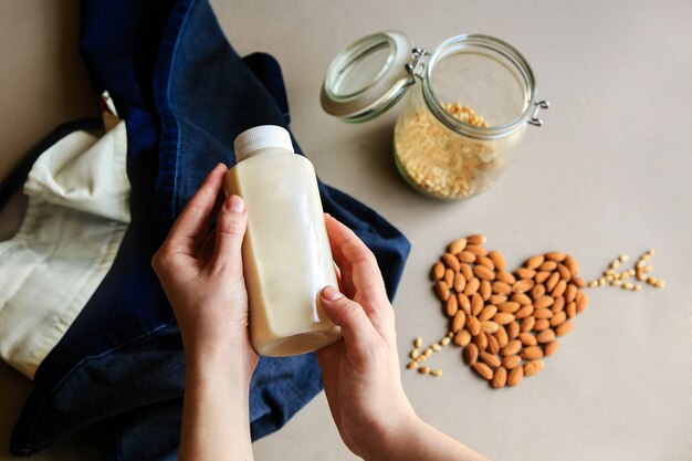 Almond milk in a bottle with almonds