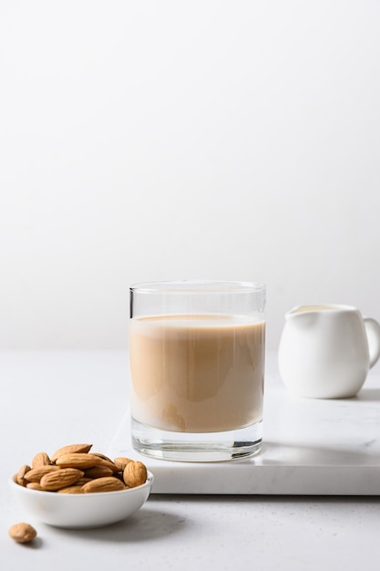 Almond milk in glass bottle and nut healthy vegan eating