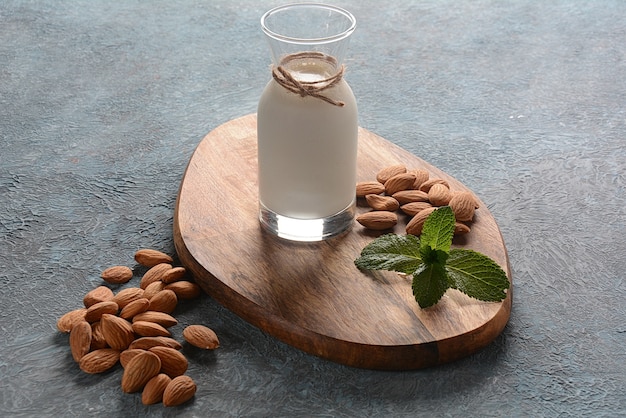 Almond milk in a glass bottle with almonds