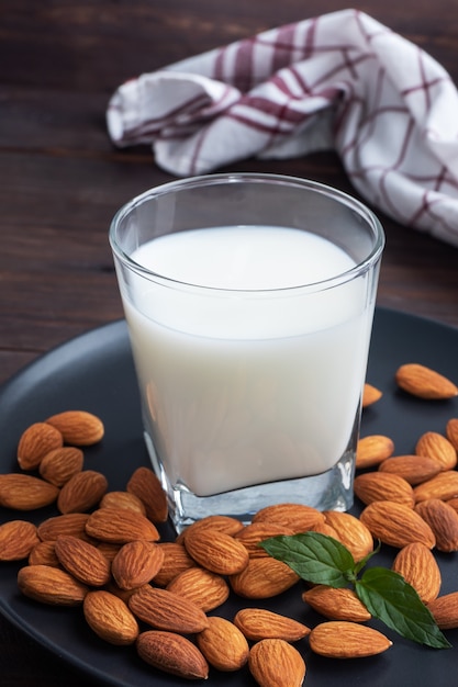 Almond milk in glass glasses on a wooden table.