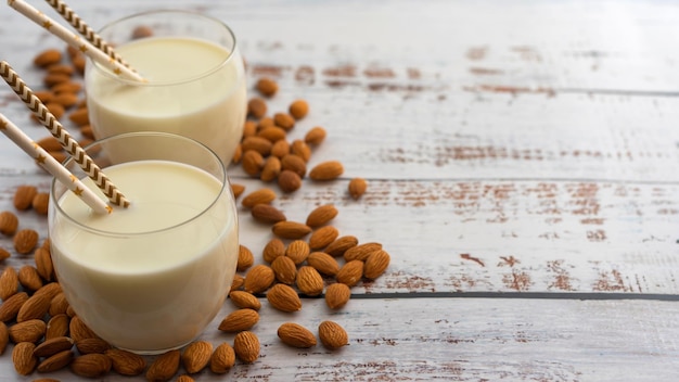 Almond milk in glass with almonds