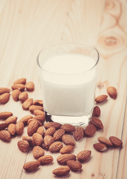 Almond milk in a glass with almonds