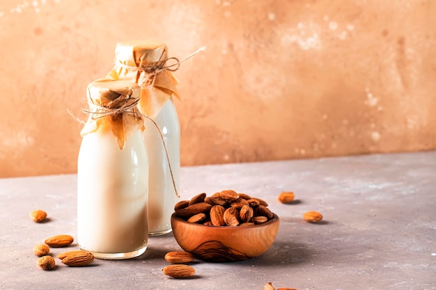 Almond milk with almond on brown table