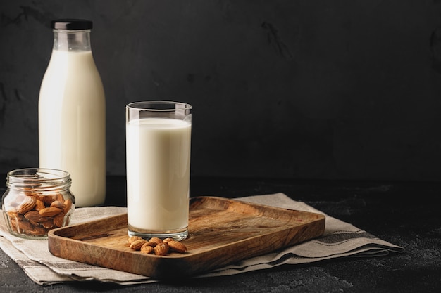 Almond milk with almond nuts in glass