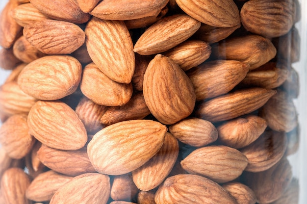 Almond nut in a glass jar closeup.