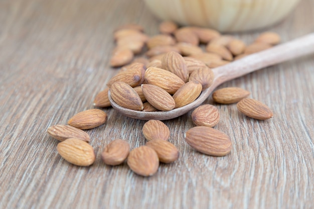 Almond nut on wood background.