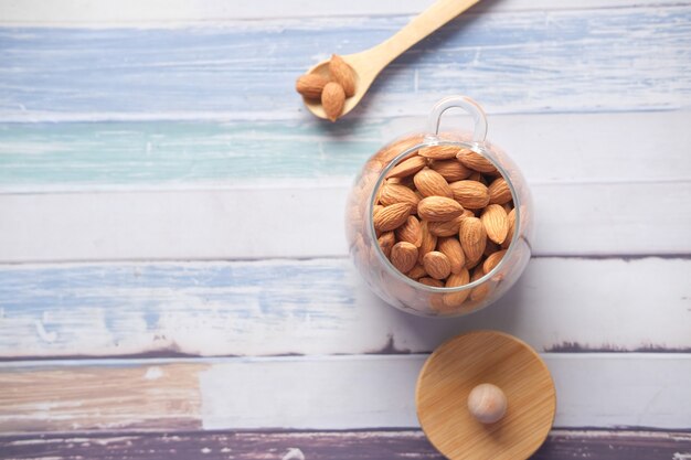 Almond nuts in a glass jar on table with copy space