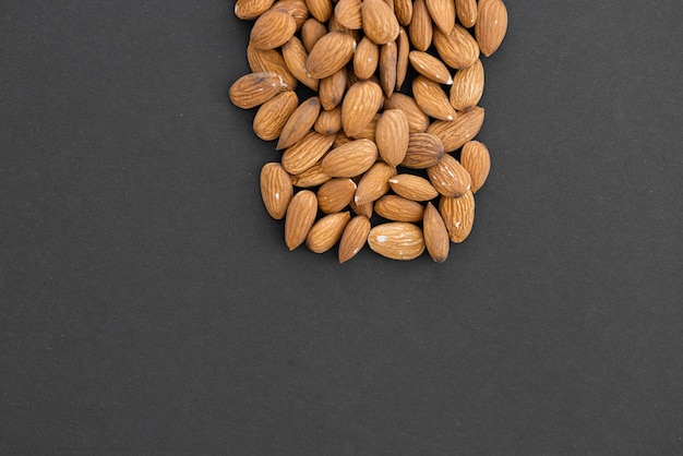 Almond nuts isolated on black background