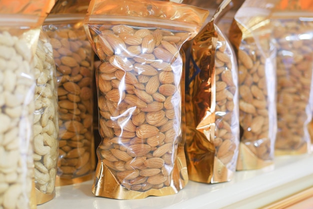 Photo almond nuts in a packet in a shelf