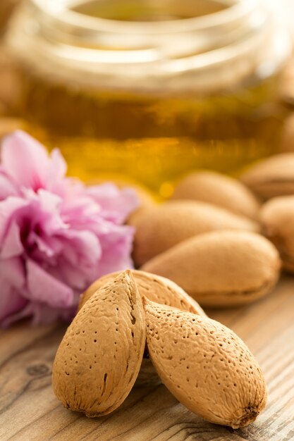 Almond oil and almonds, selective focus