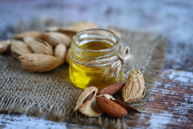 Almond oil in a jar Almonds in shells